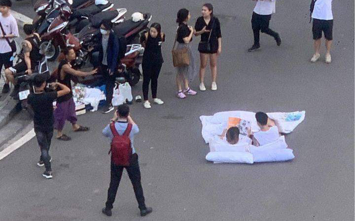Chuyện lạ nhất phố Hà Nội hôm nay: Đôi bạn trẻ bày gối, trải chăn nằm đọc sách ngay giữa quảng trường bất chấp xe cộ qua lại khiến dân mạng cực kỳ tranh cãi